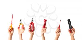 Female hands with electrician's tools on white background�