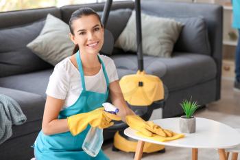 Portrait of female janitor cleaning room�