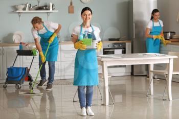 Team of janitors cleaning kitchen�