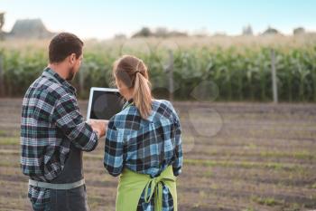 Agricultural engineers working in field�