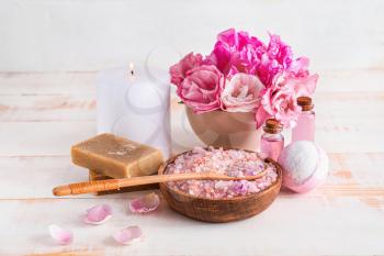Spa items with aroma candle on wooden table�