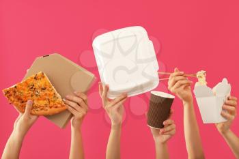 Many hands with delivery food and containers on color background�