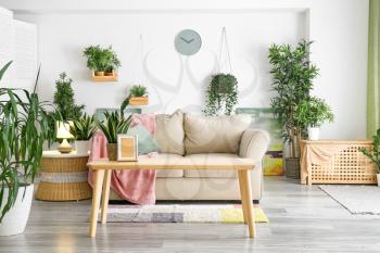 Interior of living room with green houseplants�