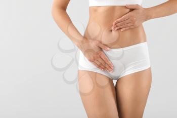 Young woman on grey background, closeup. Gynecology concept�