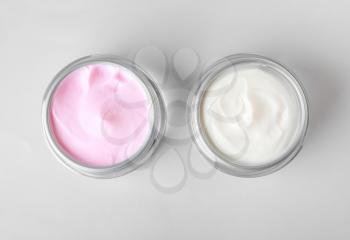 Jars of cosmetic cream on white background�