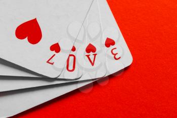 Word Love composed from playing cards on color background�
