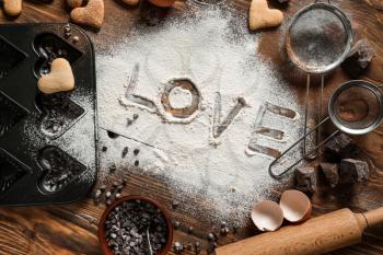 Word LOVE written on flour, top view�