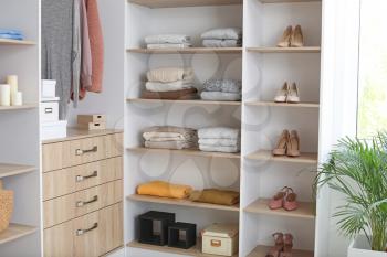 Wardrobe with stacks of clean clothes�