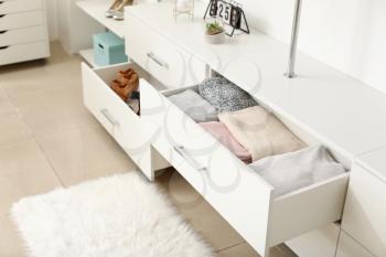 Drawers with clean clothes in dressing room�
