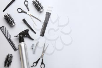 Set of hairdresser tools and accessories on light background�