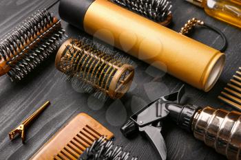 Set of hairdresser tools and accessories on dark wooden background�