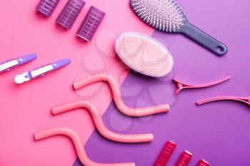 Set of hairdresser tools and accessories on color background�