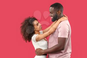 Portrait of happy African-American couple on color background�