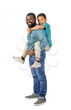 Portrait of African-American man with his little son on light background�