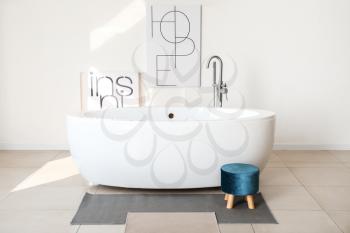 Modern ceramic bathtub in light interior�