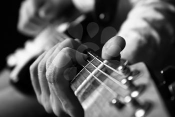 Black and white photo of man with guitar, closeup�