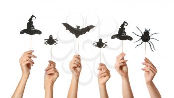Many hands with Halloween decor on white background�
