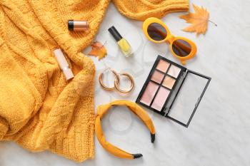 Sweater, set of decorative cosmetics and accessories on light background�