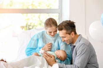 Young family with newborn baby in maternity hospital�