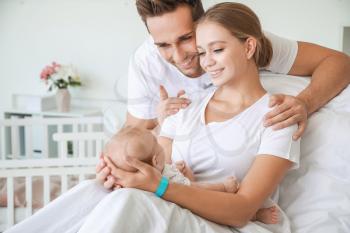 Young family with newborn baby in maternity hospital�