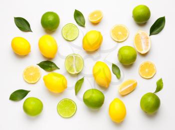 Ripe lemons and limes on white background�