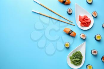 Composition with tasty sushi on color background�
