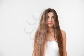 Stressed woman with tangled and smooth hair on white background�