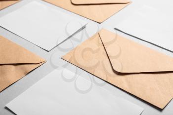 Mockups of invitations with envelopes on light background 
