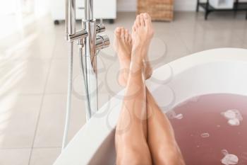 Legs of beautiful young woman relaxing in bathtub�