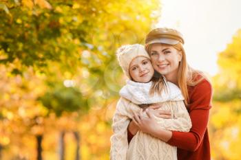 Portrait of happy mother and little daughter in autumn park�