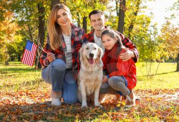 Happy family with national flag of USA in park. Memorial Day celebration�