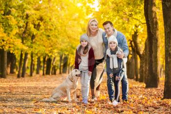 Happy family with dog in autumn park�