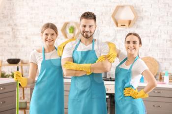 Team of janitors in kitchen�