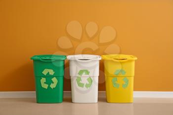 Containers for garbage near color wall. Recycling concept�