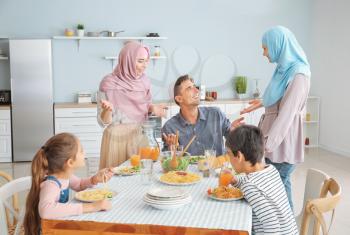 Muslim family having dinner at home�