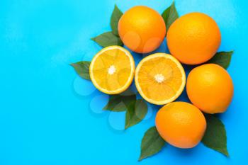 Fresh oranges on color background�