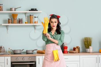 Portrait of beautiful pin-up woman going to clean kitchen�