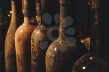 Bottles of wine in dark cellar, closeup�