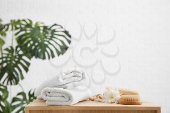 Clean towels, brush and loofah on table�