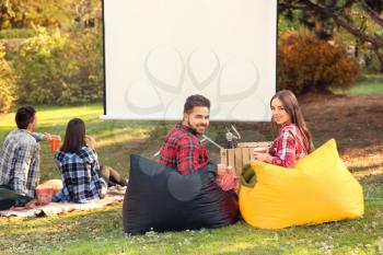 Young couple in outdoor cinema�