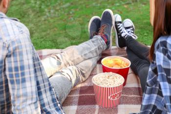 Young couple watching movie in outdoor cinema�