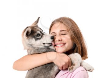 Cute teenage girl with funny husky puppy on white background�