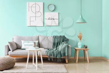 Stylish interior of living room in turquoise color�
