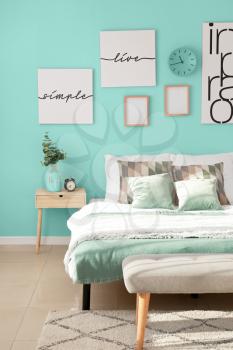 Stylish interior of bedroom in turquoise color�