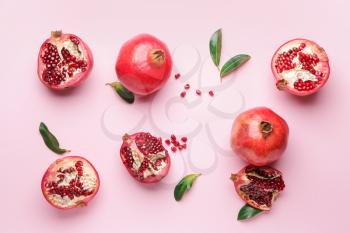 Ripe juicy pomegranates on color background�