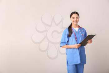 Female medical student on light background�