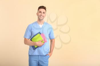 Male medical student on light background�
