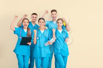 Group of happy medical students on light background�