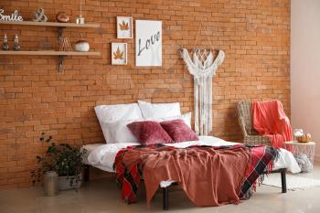 Stylish interior of modern bedroom with autumn decor�