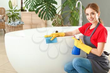 Janitor doing cleanup in bathroom�